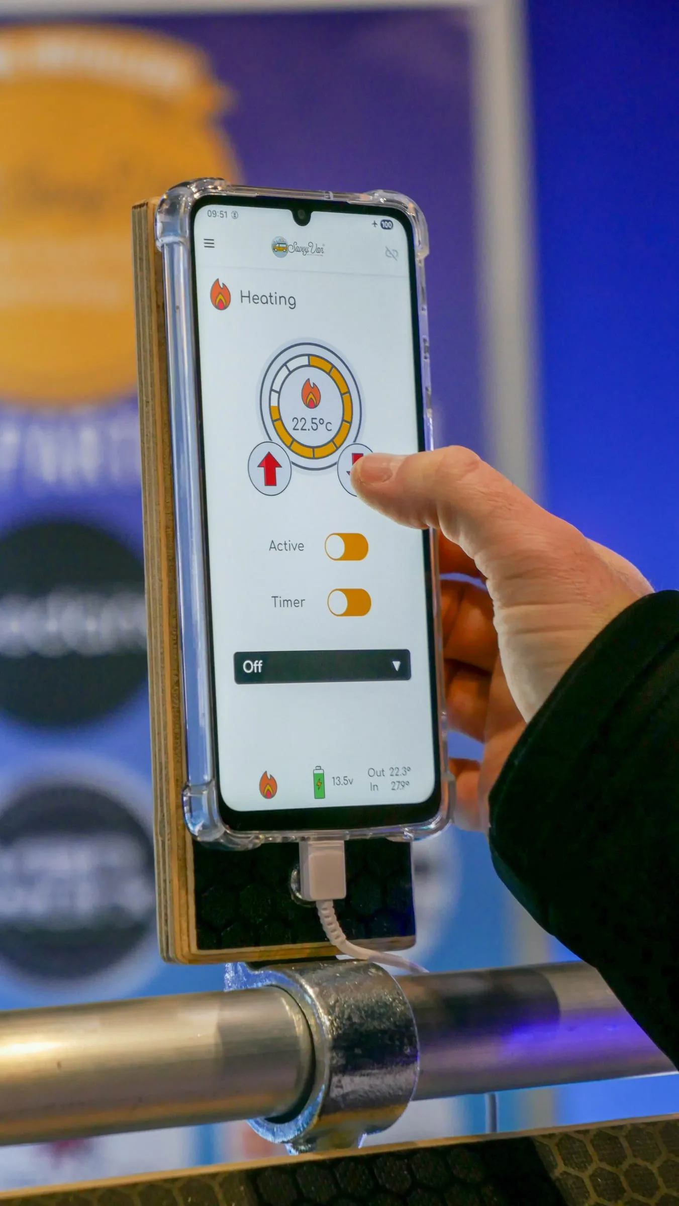 A finger adjusting the SavvyVan app heating screen on a phone, with the target set to 22.5 degrees and Active and Timer switches below it