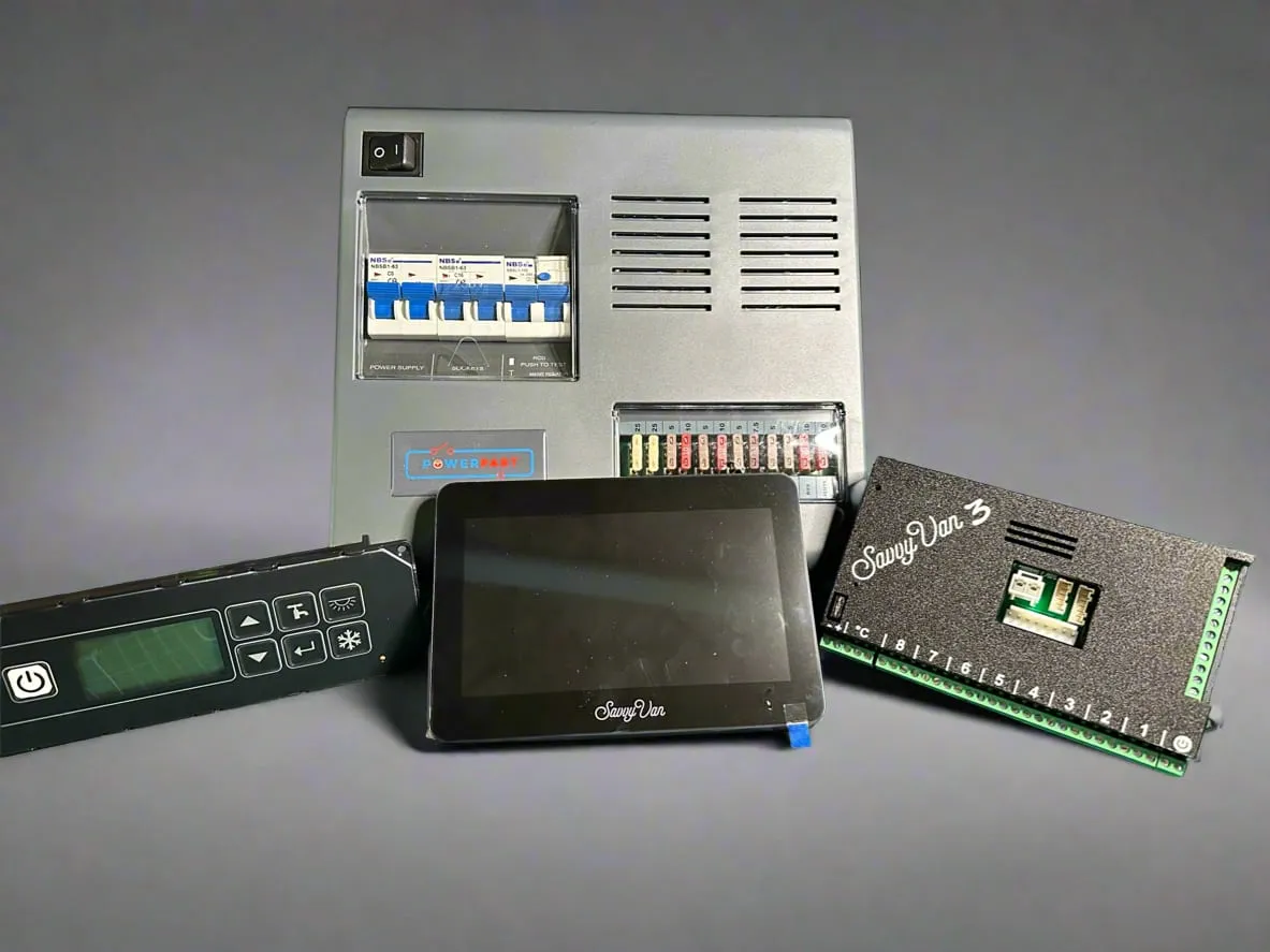 A BCA control panel and power unit laid out beside the SavvyVan3 control board and touch screen