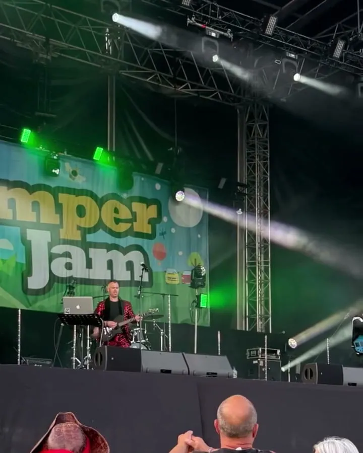 A band playing on the main stage at CamperJam, under the CamperJam sign