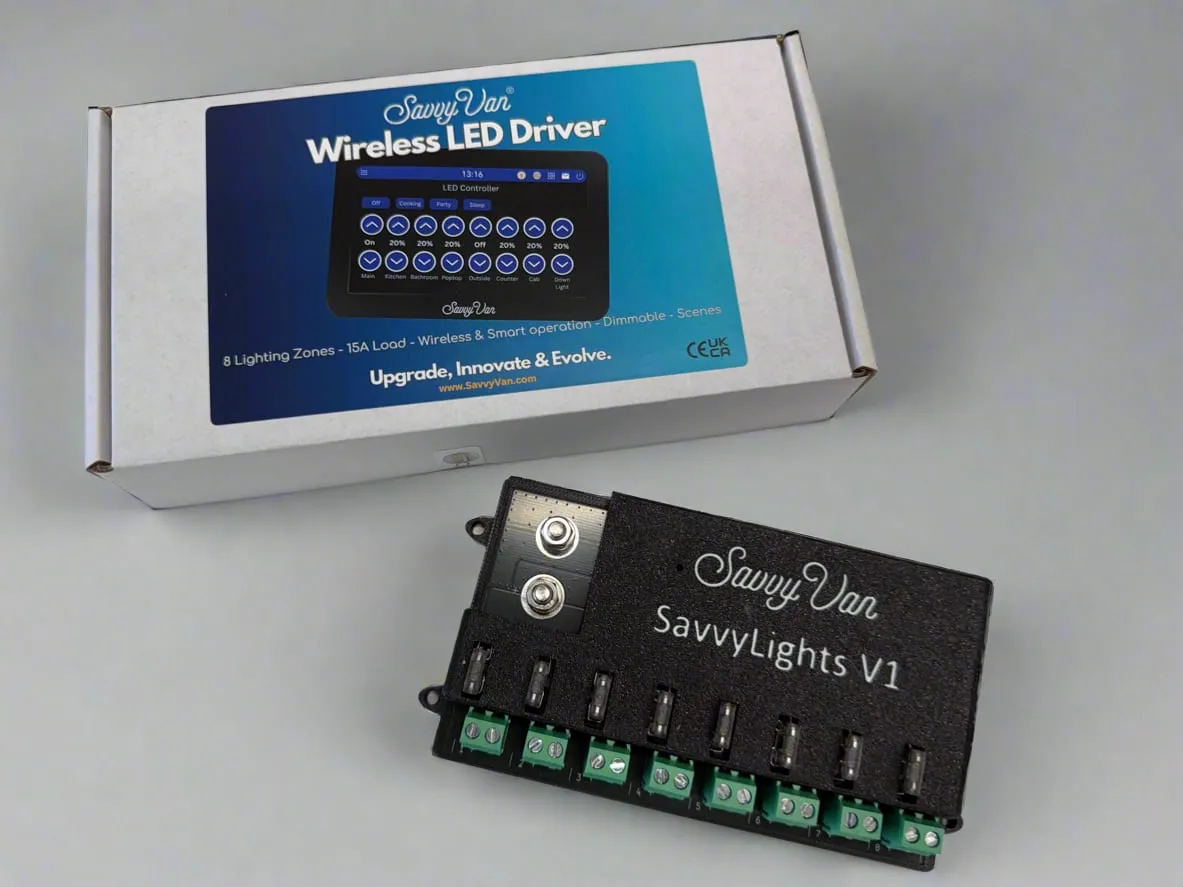 The SavvyLights driver beside its printed box, showing eight fused output channels along the front edge