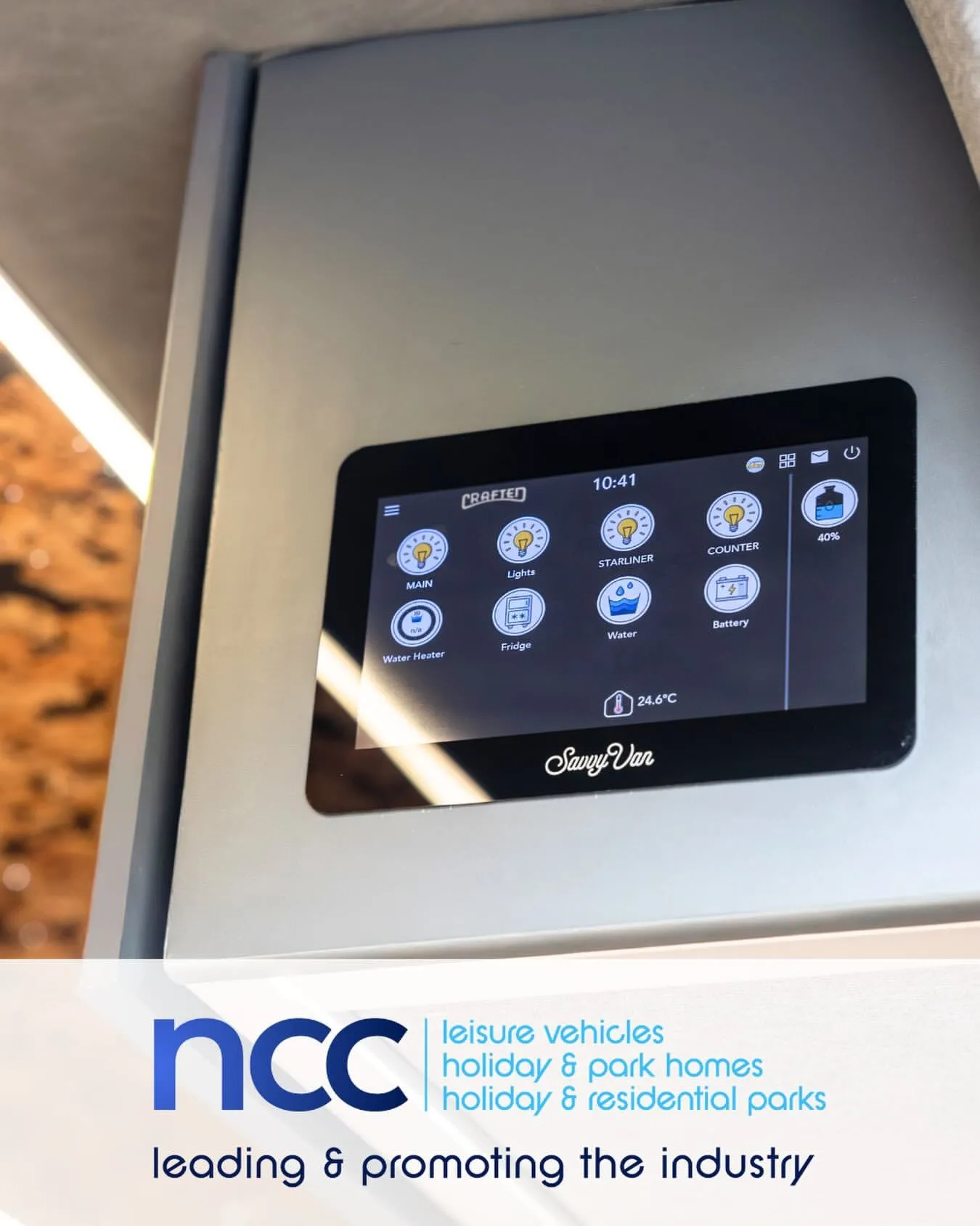 A SavvyVan panel on a van wall, above the National Caravan Council logo