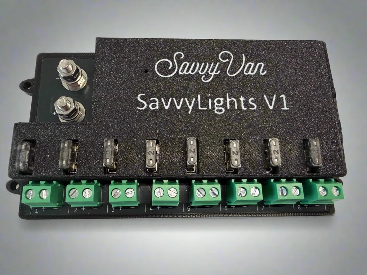 The SavvyLights driver - a black module with eight fused output channels along the front edge and two heavy supply terminals on top