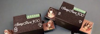 The SavvyShunt 300 and SavvyShunt 500 side by side, each a black module on a metal shunt bar with heavy copper terminals