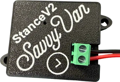 The SavvyStance V2 sensor - a small black module about the size of a matchbox, with mounting lugs at two corners and a green screw terminal carrying its red and black power leads