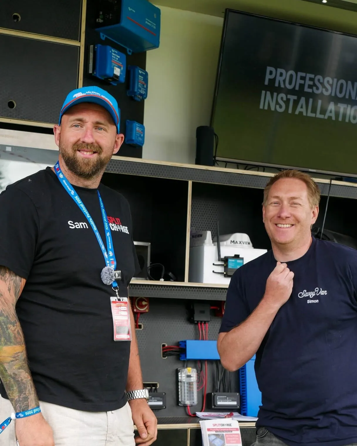 Sam from SplitCharge and Simon from SavvyVan at a show, in front of a professional installation display