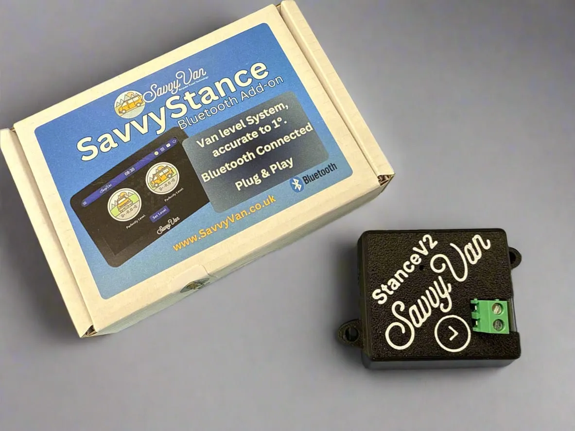 The SavvyStance sensor beside its printed box, a small black module with an arrow moulded into the top
