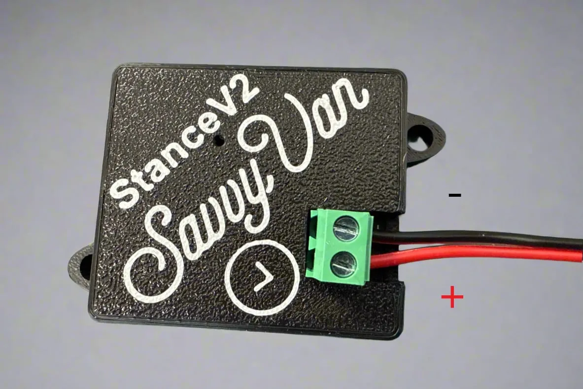 The SavvyStance sensor with red and black supply wires connected to its screw terminals