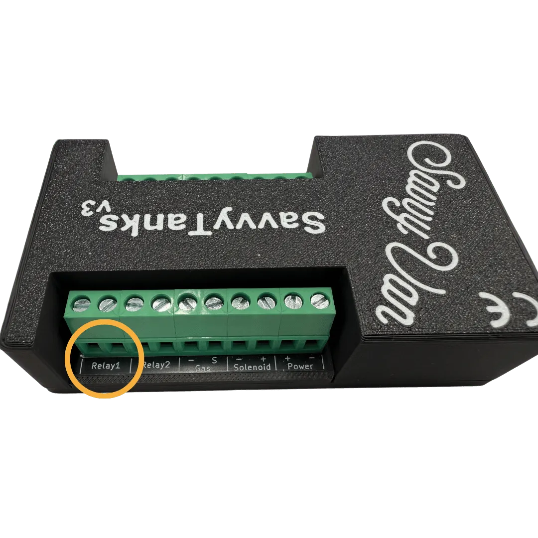 The SavvyTanks V3 module’s row of green screw terminals, with the two Relay1 terminals circled in amber at the left-hand end
