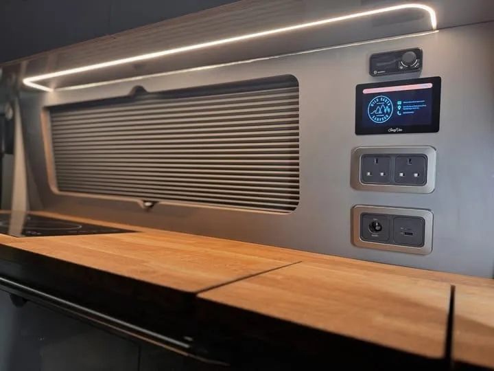 A SavvyVan3 panel with Wild Earth Campers branding fitted into a campervan interior